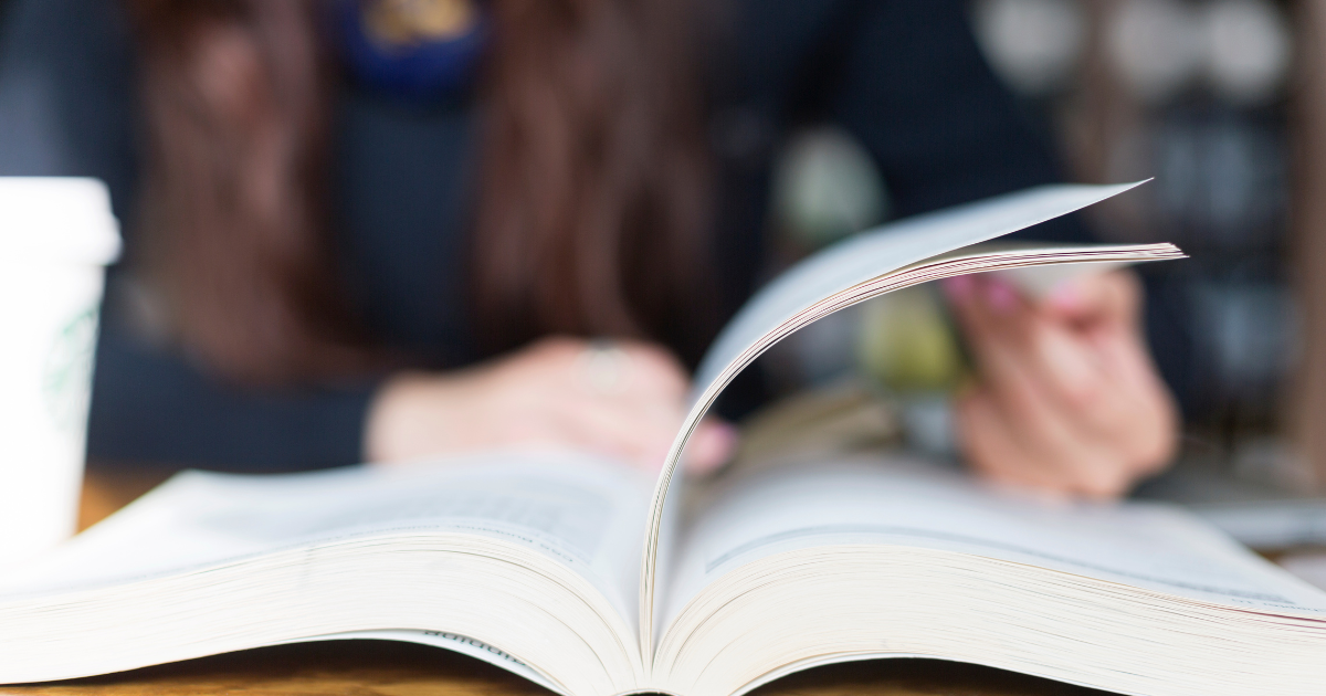 A woman flipping through an English book